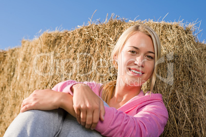 Sportive young woman relax by bales sunset