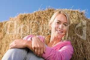 Sportive young woman relax by bales sunset