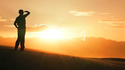 Female Watching the Sun Setting on her Desert Hike