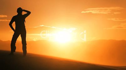 Female Watching the Sun Setting on her Desert Hike