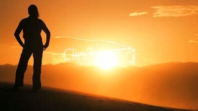 Female Hiker Watching the Sunset in the Desert