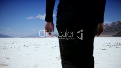 Solitary Figure Crossing a Dry Salt Lake