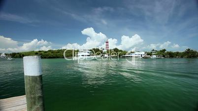 Tropical Island Lighthouse with Passing Yachts