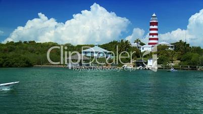 Tropical Island Lighthouse with Passing Craft