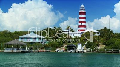 Tropical Island Lighthouse with Passing Craft