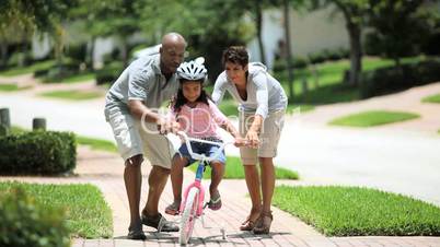 Little African American Girl Learning to Ride a Bike