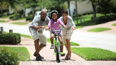 Little African American Girl Learning to Ride a Bike