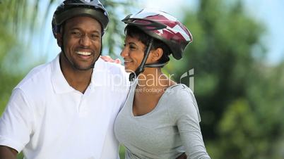 Portrait of Young Ethnic Couple Cycling Together