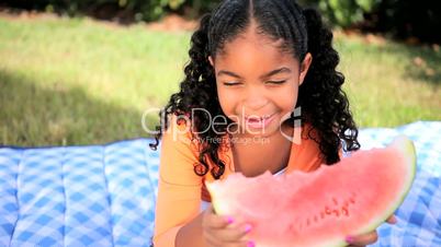 Little African American Girl Eating Fresh Fruit