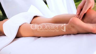 Female Client Relaxing with Leg Massage at Health Spa