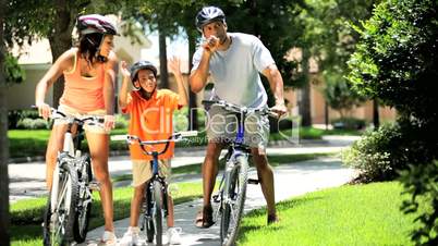 Healthy Ethnic Family Cycling Together