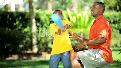 Ethnic Father & Son Practicing Baseball Swing