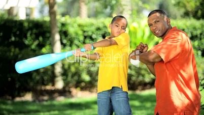 Ethnic Father & Son Practicing Baseball Swing