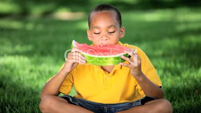 Young Ethnic Boy Eating Healthy Water Melon