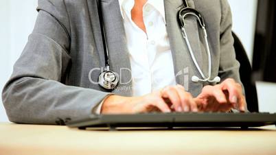 Senior Female Medical Consultant Using Computer