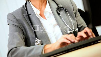 Female Medical Consultant Updating Records