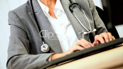 Senior Female Medical Consultant Using Computer