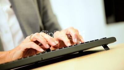 Mature Female Business Consultant Using Keyboard
