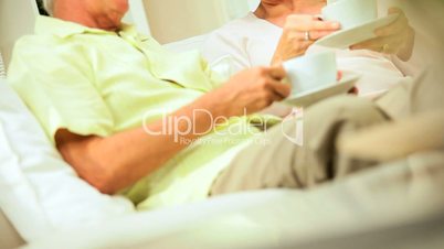 Retired Couple Relaxing at Home with Morning Coffee
