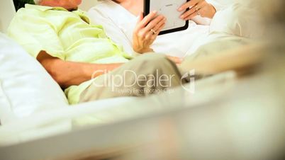 Mature Couple Using a Wireless Tablet at Home