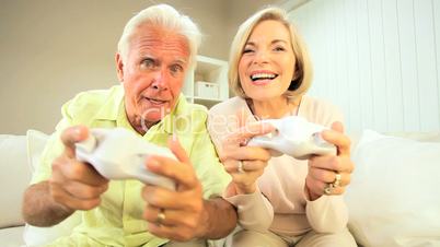 Retired Couple Competing on Games Console