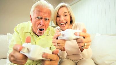 Senior Couple Playing Electronic Games