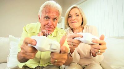 Senior Couple Having Fun with Electronic Games
