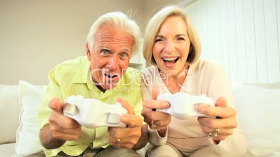 Senior Couple Playing Electronic Games