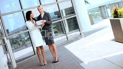 Two Caucasian Businesswomen Using Wireless Tablet