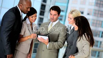 Multi Ethnic Business Team With Wireless Tablet