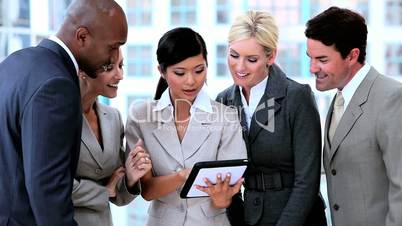 Multi Ethnic Business Team With Wireless Tablet