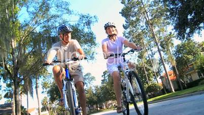 Fit & Healthy Retired Couple Cycling Together