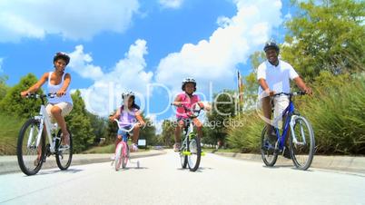 Young Ethnic Family Cycling Together