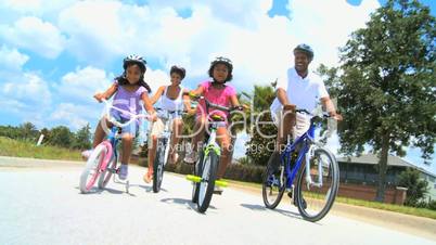 Healthy Ethnic Family Cycling Together