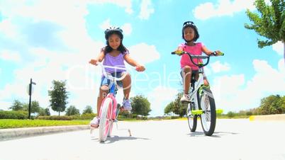 Cute Little African American Girls on Bicycles