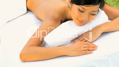 Female Spa Client Receiving Hot Stone Therapy