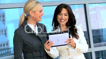 Two Caucasian Businesswomen Using Wireless Tablet