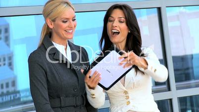 Meeting of Two Businesswomen Using Wireless Tablet