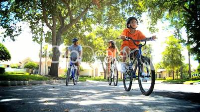 Young Ethnic Family Cycling Together