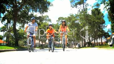 Healthy African American Family Cycling Together