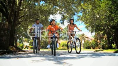 Young Ethnic Family Keeping Fit Cycling Together