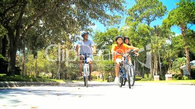 Healthy Ethnic Family Cycling Together