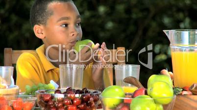 Little Ethnic Boy Enjoying an Apple with Lunch