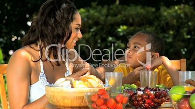 Ethnic Mother & Son Eating Healthy Lunch Outdoors