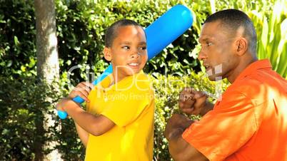 Ethnic Father Teaching Young Son Baseball