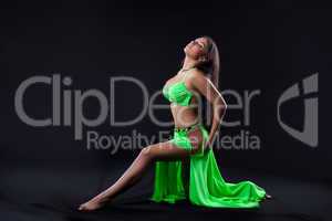 Beautiful young girl dance in green arabic costume