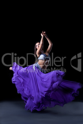 beauty dancer posing in dark with fly purple veil