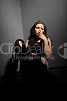 Beauty sad grunge girl sit in corner and smoke