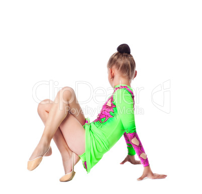 young gymnast girl in green sit on white