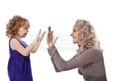 Happy mother and child play together isolated